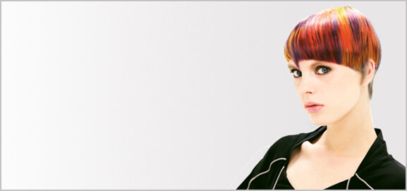 Female hair model with short red, yellow and purple hair.